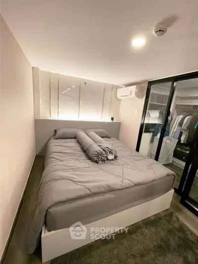 Cozy modern bedroom with stylish decor and ample closet space