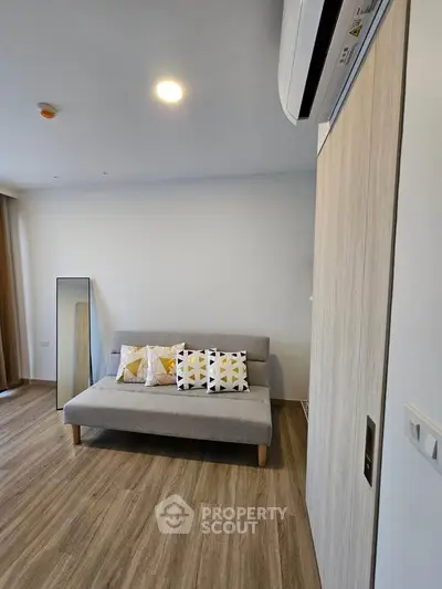 Modern living room with stylish sofa and wooden flooring