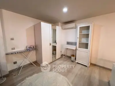 Cozy bedroom with modern furniture and air conditioning, perfect for comfort and relaxation.