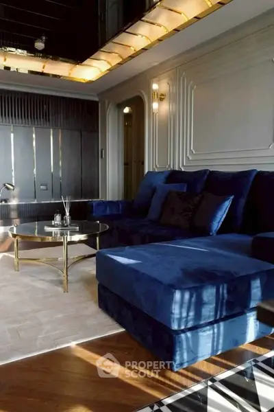Luxurious living room with plush blue sofa and elegant decor, perfect for modern comfort and style.