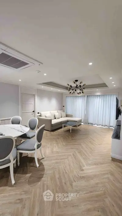 Elegant living room with modern decor and spacious layout, featuring stylish furniture and ambient lighting.