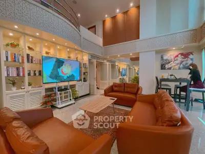 Luxurious living room with high ceilings, elegant decor, and cozy leather sofas in a modern duplex apartment.