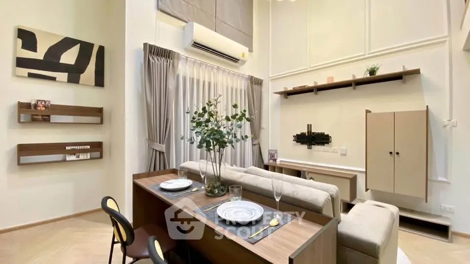 Modern living room with high ceilings, stylish decor, and elegant dining setup.
