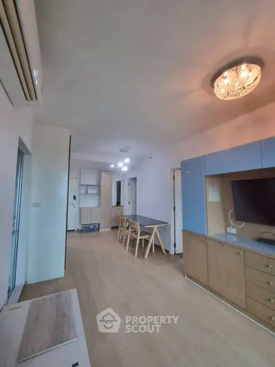 Spacious modern living room with elegant lighting and wooden flooring