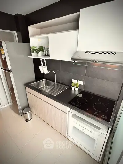 Modern kitchen with sleek cabinetry and built-in appliances in a stylish apartment.