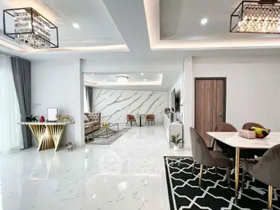 Luxurious open-plan living and dining area with modern decor and marble flooring.
