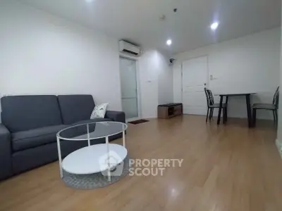 Spacious living room with modern furniture and wooden flooring