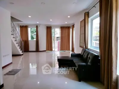 Spacious living room with modern design and large windows for natural light.