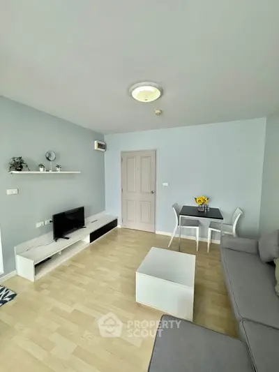 Modern living room with sleek furniture and natural light, perfect for cozy gatherings.