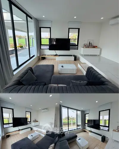 Spacious modern living room with large windows and stylish furniture, offering a bright and inviting atmosphere.