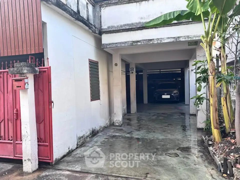 Charming residential property with spacious driveway and covered parking area, ideal for urban living.