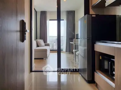 Modern apartment with open kitchen and cozy living room leading to a balcony with city view.