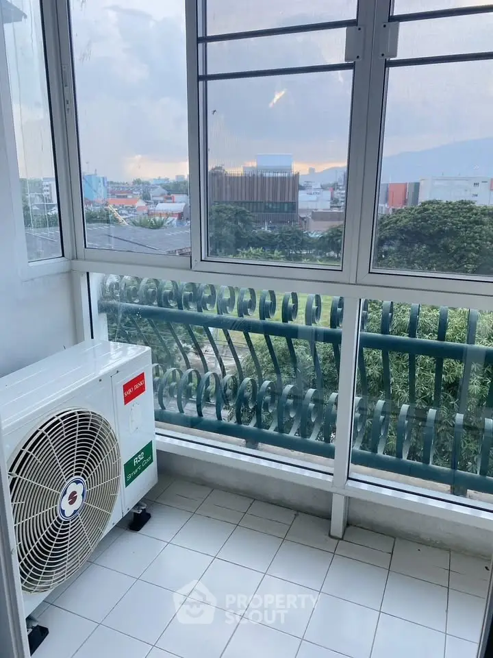Spacious balcony with city view and air conditioning unit, perfect for relaxation.