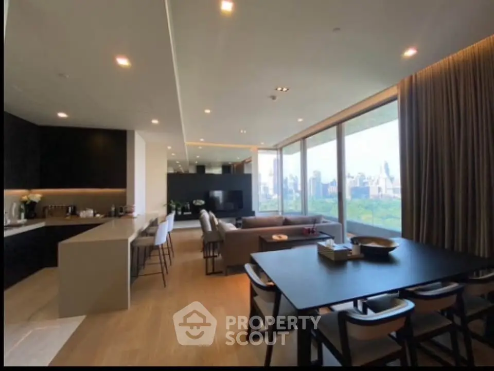 Luxurious open-plan living room with stunning city view and modern kitchen