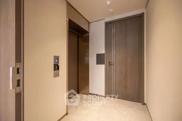 Modern apartment elevator lobby with sleek design and wooden accents