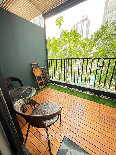 Charming balcony with wooden flooring and lush green view in modern apartment