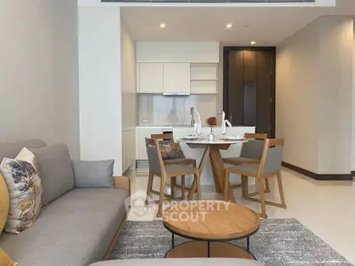 Modern open-plan living room with stylish furniture and dining area in a contemporary apartment.