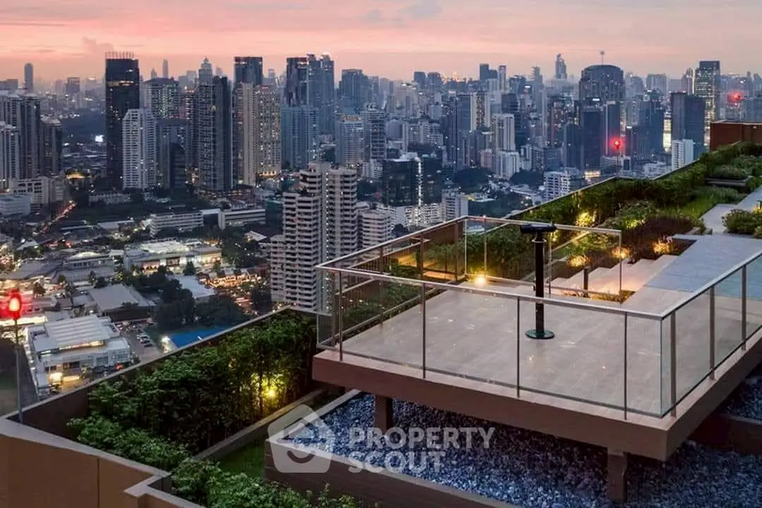 Stunning rooftop garden with panoramic city skyline view at sunset.