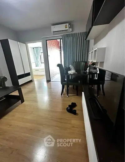 Spacious living room with modern decor and wooden flooring