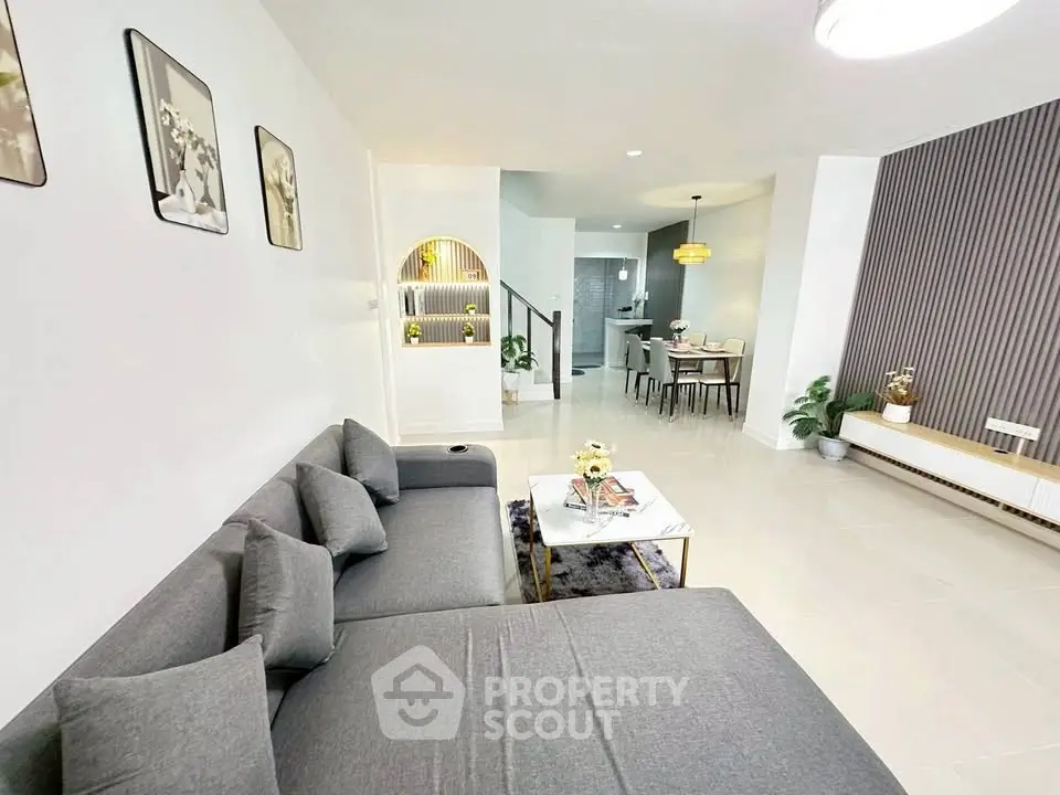 Modern living room with stylish decor and open dining area