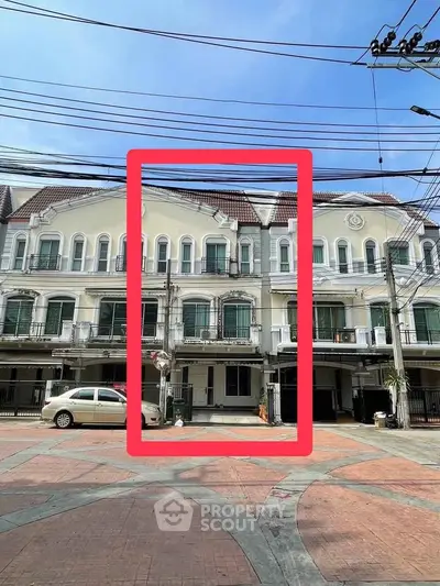 Charming townhouse with classic facade and spacious parking area in vibrant neighborhood.