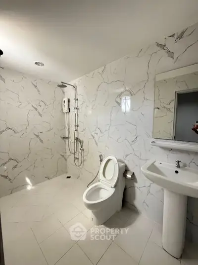 Modern bathroom with marble walls and sleek fixtures