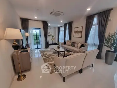 Elegant living room with modern decor, large windows, and stylish furniture, perfect for relaxation and entertainment.