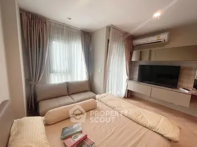 Cozy bedroom with modern decor and natural light, featuring a comfortable bed and stylish sofa.