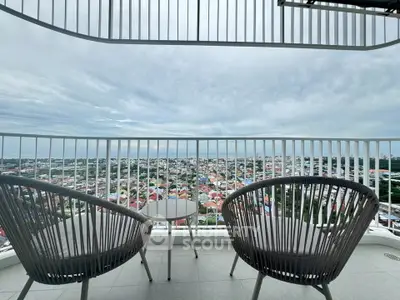 Stunning balcony view with modern seating overlooking a vibrant cityscape.