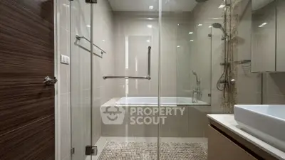 Modern bathroom with glass shower and built-in bathtub