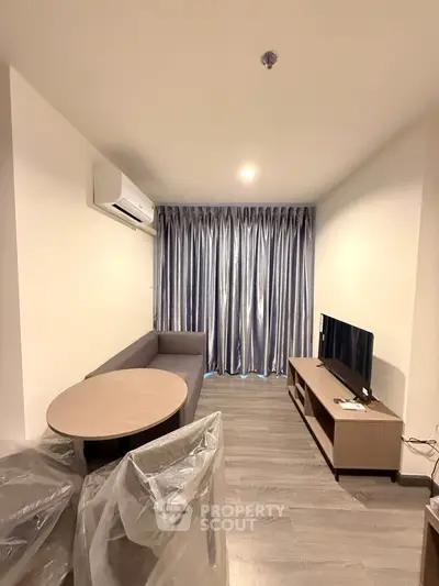 Modern living room with sleek furniture and elegant curtains, perfect for cozy relaxation.