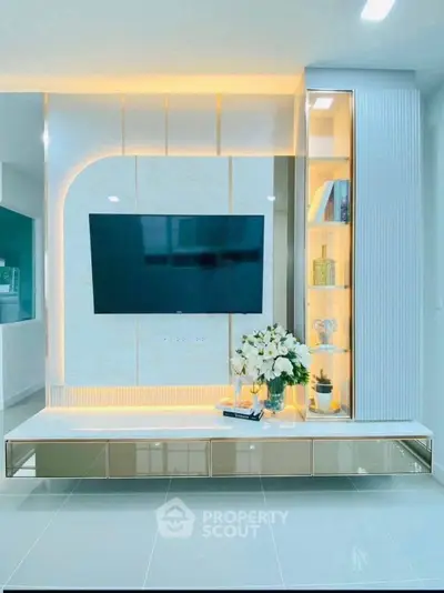 Modern living room with sleek TV unit and elegant lighting