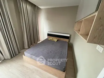 Modern minimalist bedroom with wooden flooring and built-in shelves, featuring a cozy bed and elegant curtains.