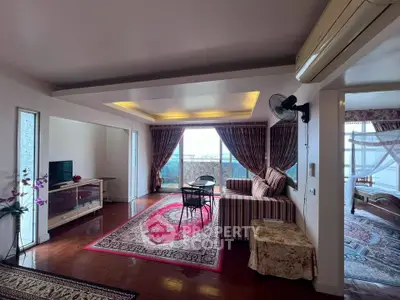 Spacious living room with elegant decor and stunning city view from large windows.