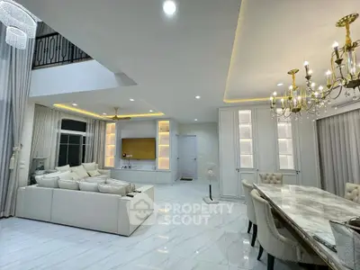 Luxurious open-plan living room with elegant chandeliers and marble flooring