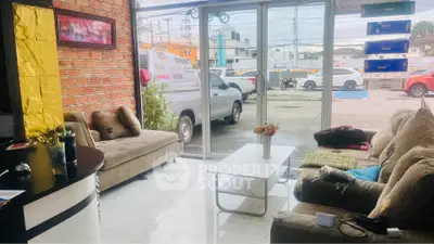 Cozy living room with large windows and modern decor, perfect for relaxation and entertaining.