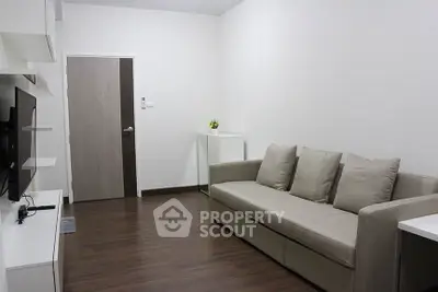 Modern living room with sleek design and comfortable sofa in a minimalist apartment.