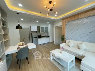 Modern open-layout living room with stylish decor and integrated kitchen area.