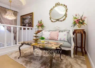 Elegant living room with vintage decor, ornate mirror, and plush rug, perfect for sophisticated relaxation.