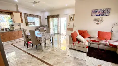 Spacious open-plan living and dining area with modern decor and natural light.