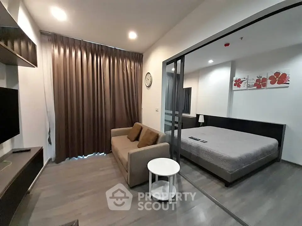 Modern studio apartment with cozy living area and stylish bedroom
