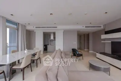 Spacious modern living room with open kitchen and elegant dining area in luxury apartment.