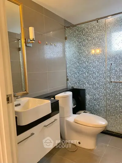 Modern bathroom with sleek fixtures and glass shower enclosure