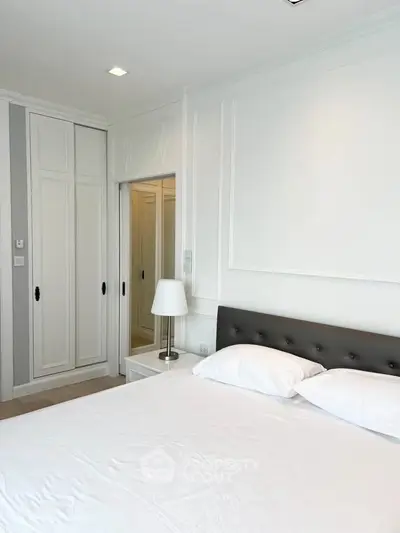 Elegant bedroom with white decor and built-in wardrobe