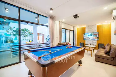 Luxurious living room with pool table and modern decor, perfect for entertainment and relaxation.