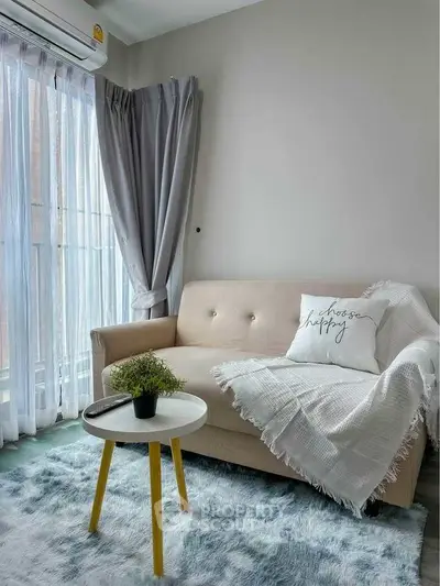 Cozy living room with stylish sofa, chic decor, and natural light