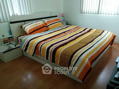 Cozy bedroom with striped bedding and natural light