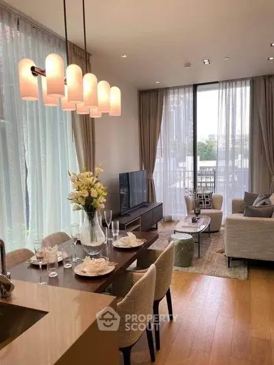 Elegant living room with modern decor, large windows, and stylish dining area in a luxury apartment.