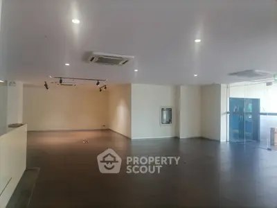 Spacious commercial interior with modern lighting and glass entrance
