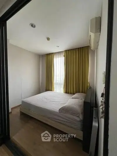 Cozy bedroom with natural light and modern decor in a stylish apartment.